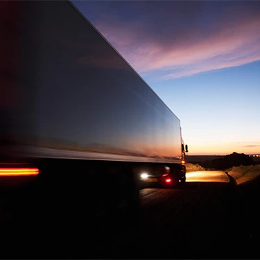 Tractor-trailer driving down road